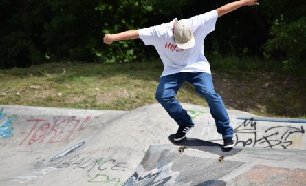 A skateboarder skates in a park.
